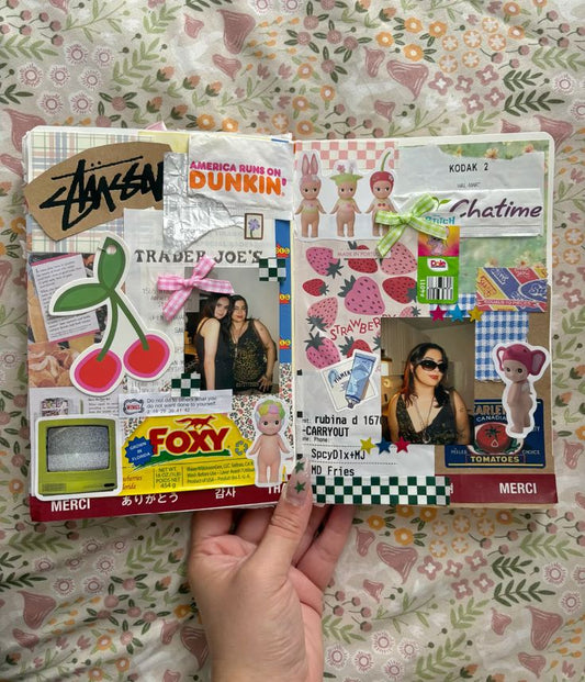 An Open Junk Journal with cut out arts and crafts papers, sticker and printed photos.
